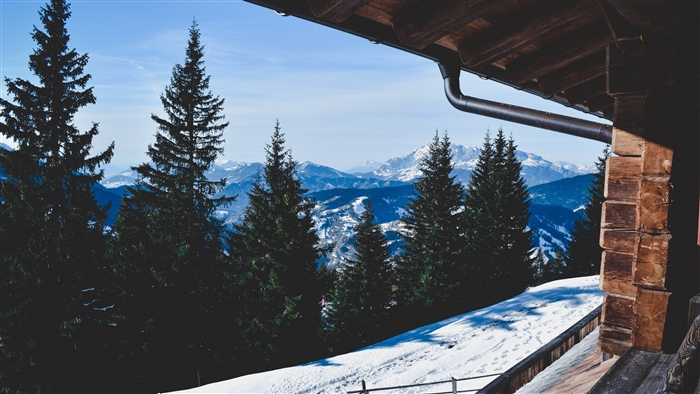Winter mountain view from a wooden cabin