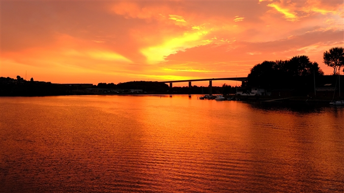 River sunset with bridge and ripples 4K