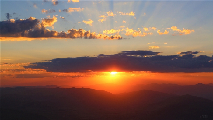 Sunset over mountains with clouds 4K