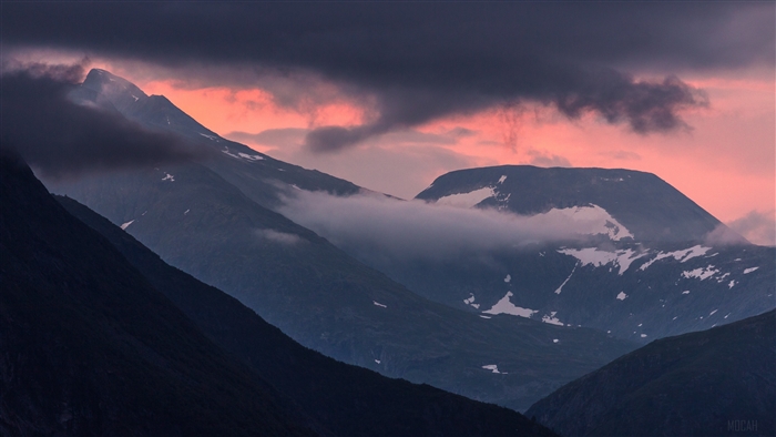 Mountains with snow and clouds at sunset, Norway 4K