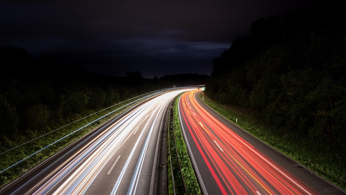 Highway at night with light trails