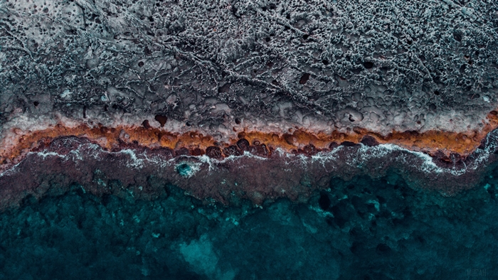 Aerial view of rocky coast with ocean waves