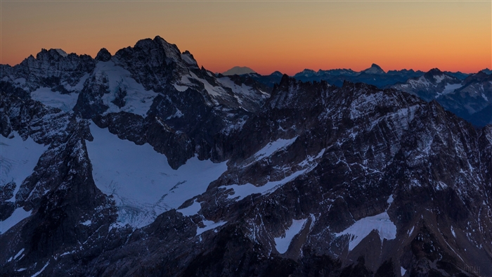 Snowy mountain peaks at sunset 4K