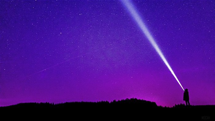 Man with flashlight under starry sky 4K