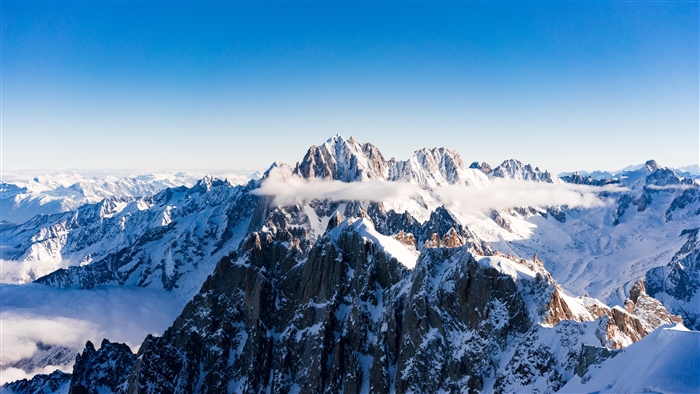 Snow-capped mountains under a clear blue sky