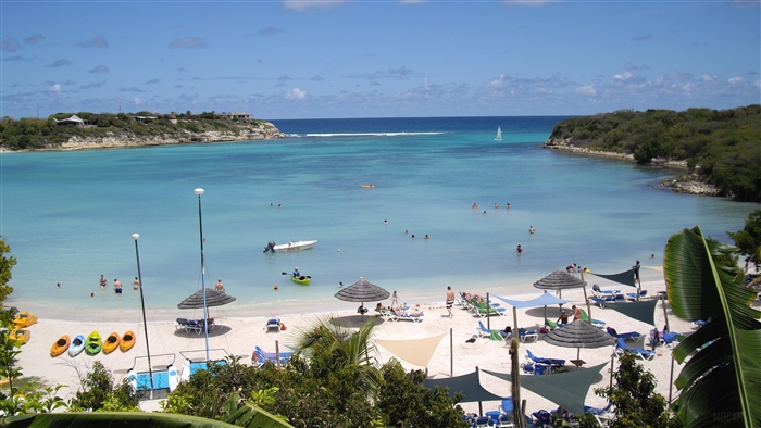 Tropical beach with people swimming and relaxing