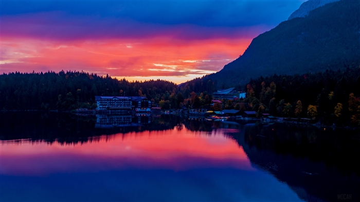 Sunset over a lake in Bavaria, Germany with buildings