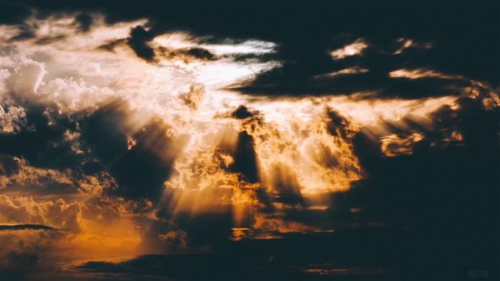 Sunbeams through dark and light clouds