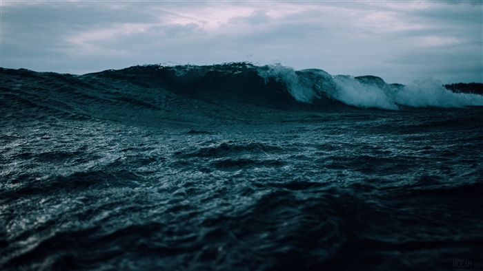 Dark ocean waves under cloudy sky 4K