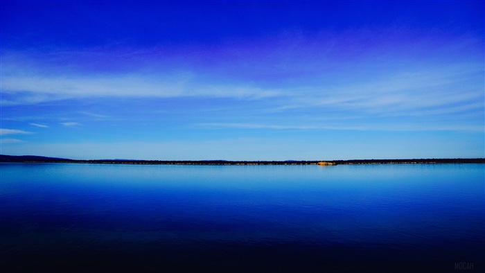 Vast blue lake under a clear sky