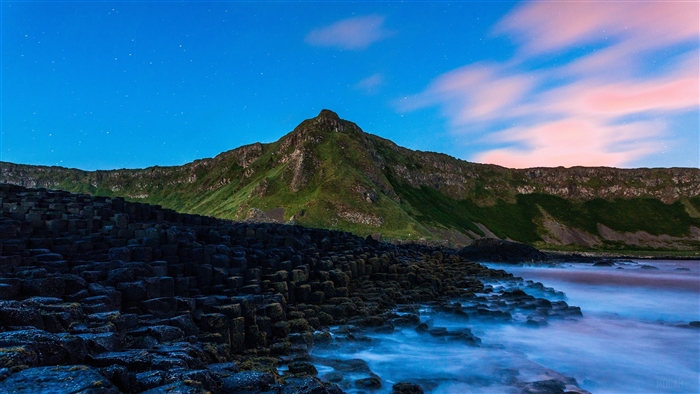 Giant's Causeway stones and mountain at dusk 4K