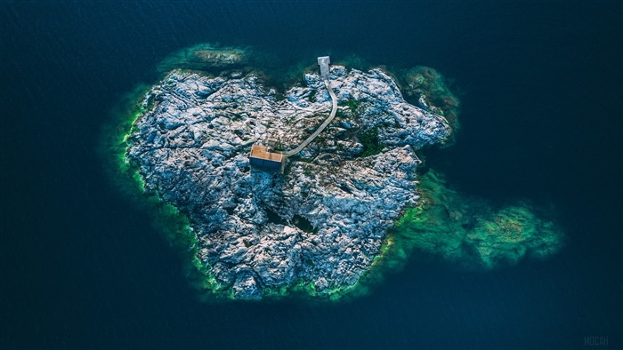 Aerial view of a small island with a cabin in Sweden