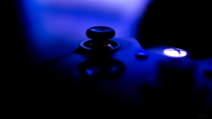 Close-up of a backlit video game controller joystick