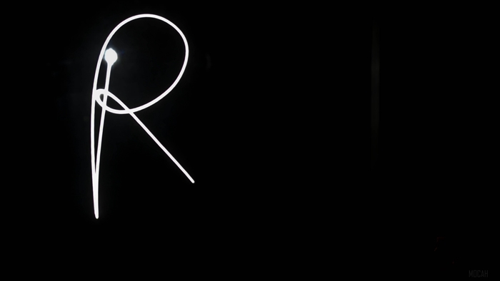 Light art letter R on dark background 4K