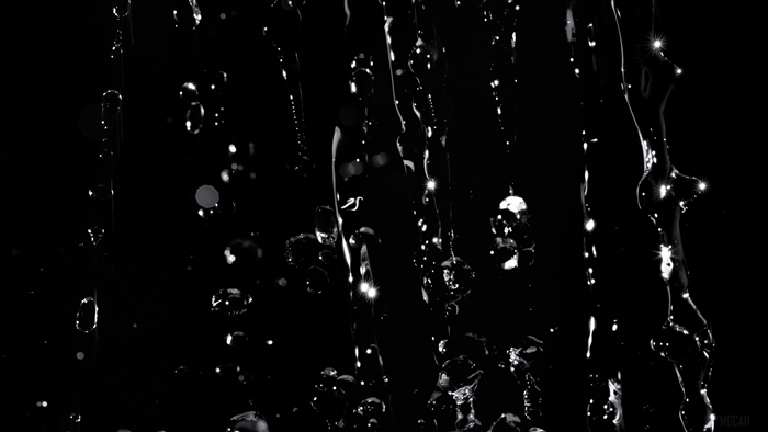 Black and white water jets and drops