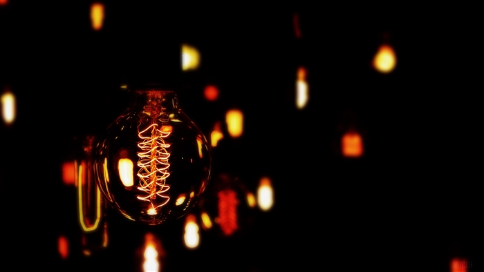 Lightbulb with spiral filament and bokeh
