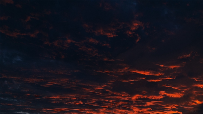 Dark clouds with orange sunset glow 4K