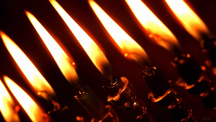 Close-up of burning candles in darkness 4K