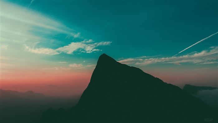 Mountain peak at sunset with clouds