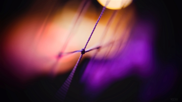 Close-up of a knotted thread with bokeh lights
