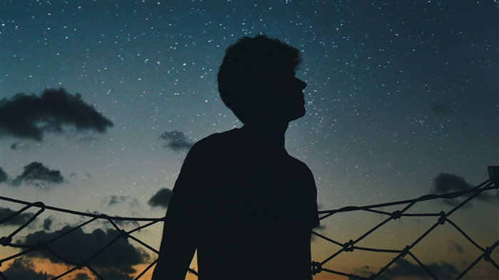 Silhouette of a person against a starry sky