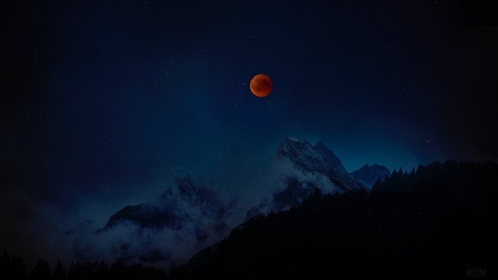 Red moon over starry sky and mountains 4K
