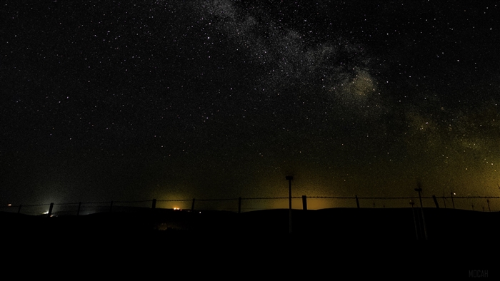 Milky Way over a fence at night