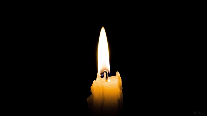 Burning candle with flame in the dark 4K