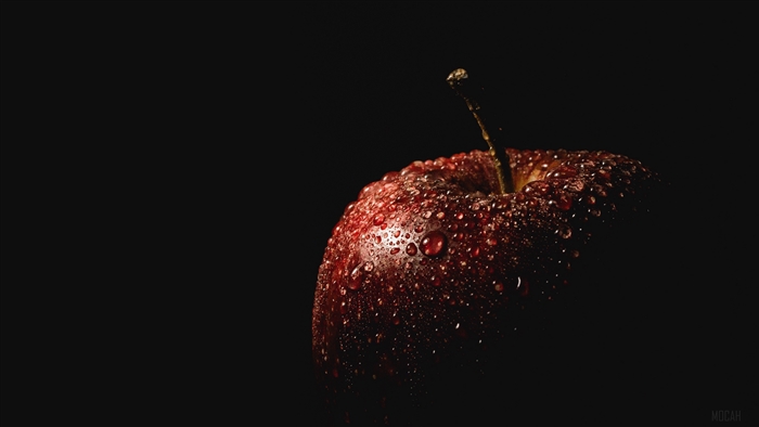 Red apple with water drops on black background 4K