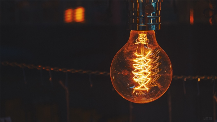 Close-up of a glowing Edison light bulb with a spiral filament