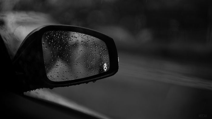 Car side mirror with raindrops in black and white