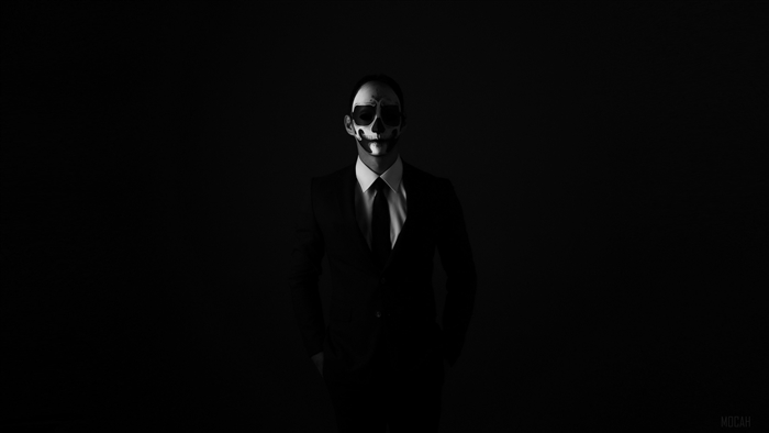 Man in suit with skull face paint