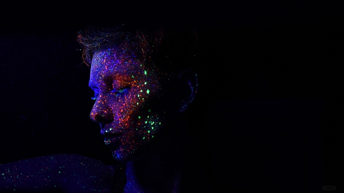 Woman with ultraviolet makeup and sequins