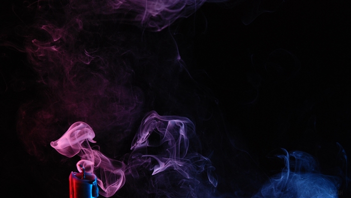 Colored smoke rising from a candle