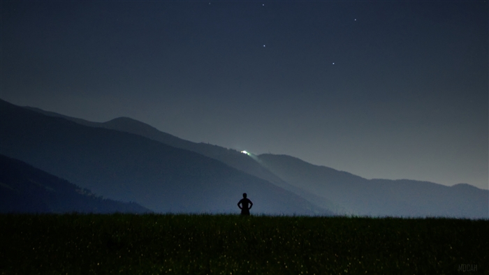 Man silhouette in field at night with stars
