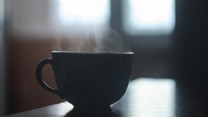 Cup of steaming coffee on a table