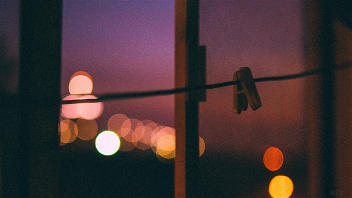 Clothespin on a wire with bokeh lights
