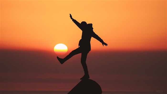 Silhouette of a person balancing at sunset 4K