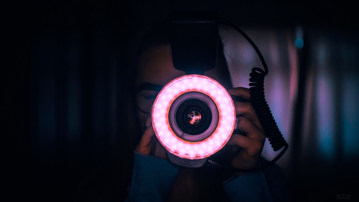 Photographer with ring light and camera