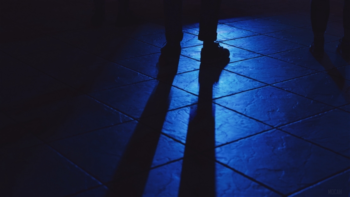 Shadows of feet on a blue tiled floor 4K