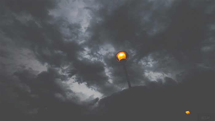 Street lamp and lantern against dark clouds 4K