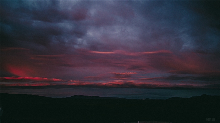 Dramatic sunset sky over dark hills 4K