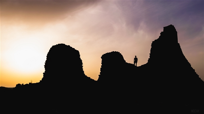 Silhouette of a person on ruins at sunset in Sardinia, Italy 4K