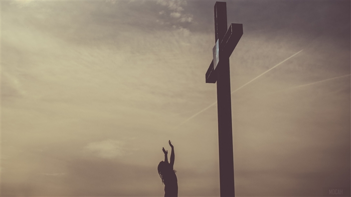Silhouette Praying Near a Cross at Sunset 4K