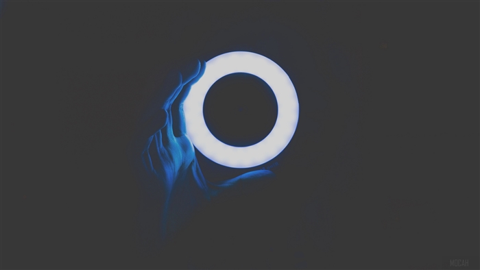 Hand holding a glowing circle