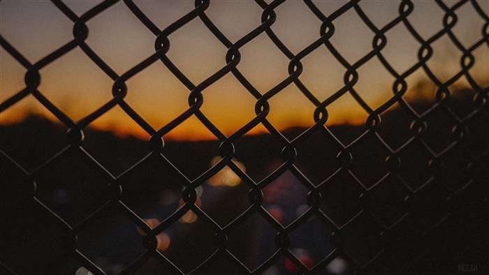 Chain-link fence at sunset