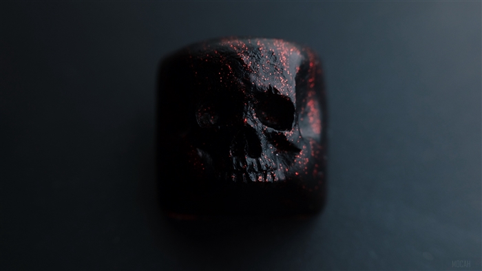 Black skull figurine with red sparkles 4K