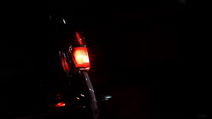 Close-up of a car's red taillight at night