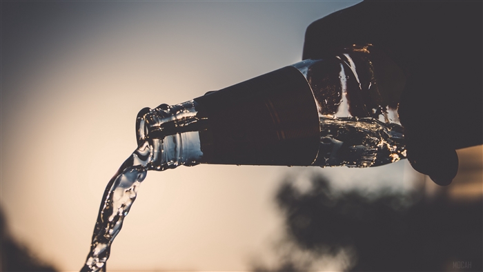 Water Pouring from Bottle in Golden Light 4K
