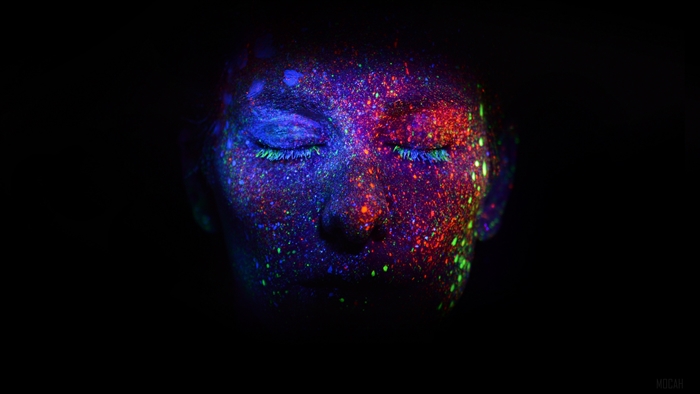 Face covered in ultraviolet paint